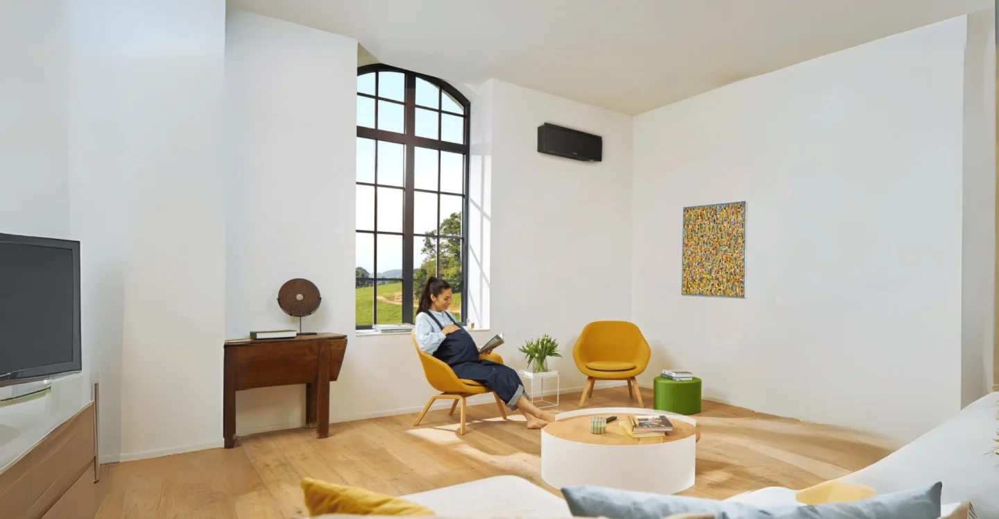 Een mooie airco van Daikin aan een witte muur in de woonkamer.